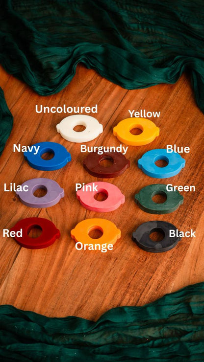 Set of colored washers on a wooden surface with labels underneath.