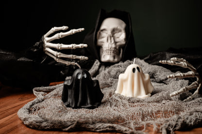 Skeleton figure with black and white ghosts on a dark background